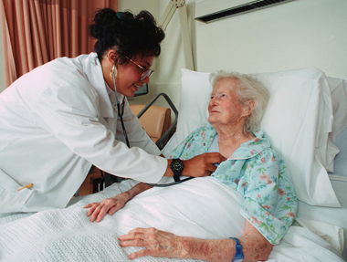 nurse and oldwoman in hospital bed - www.Social-Security.biz